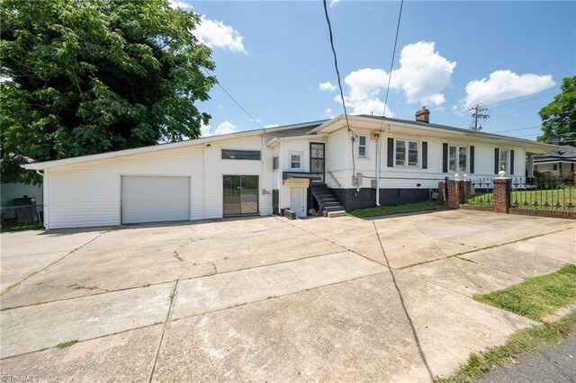 1414 E 3rd St, Winston-Salem, NC 27101 - view of front facade with driveway, a chimney, and a detached garage