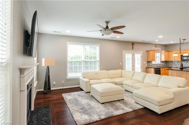 living room with ceiling fan, sink, dark hardwood / wood-style floors, and french doors