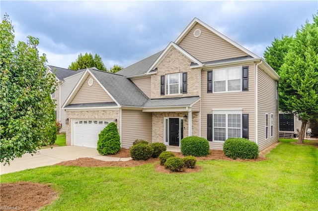 view of front of home with a garage and a front lawn