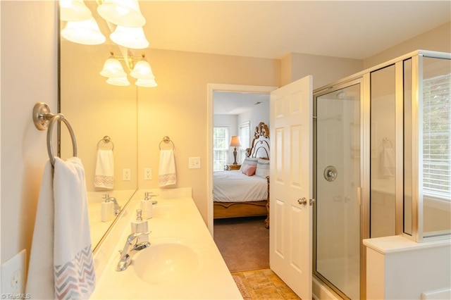 bathroom featuring vanity, a chandelier, and an enclosed shower