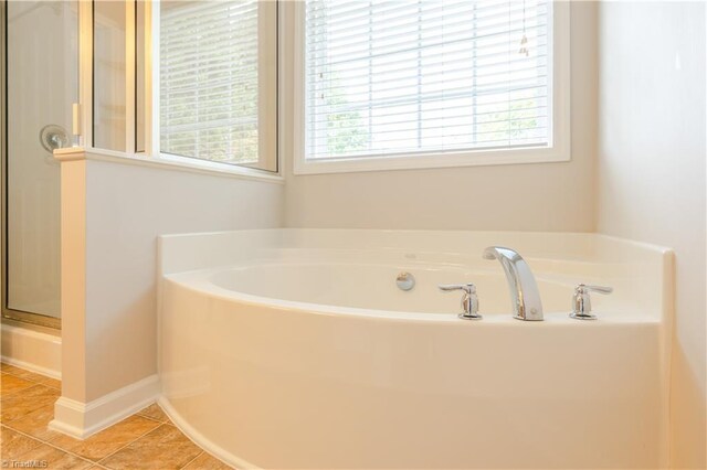 bathroom featuring a healthy amount of sunlight, tile patterned flooring, and shower with separate bathtub