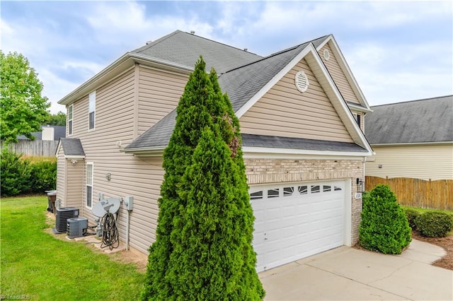 view of property exterior with a garage and central air condition unit