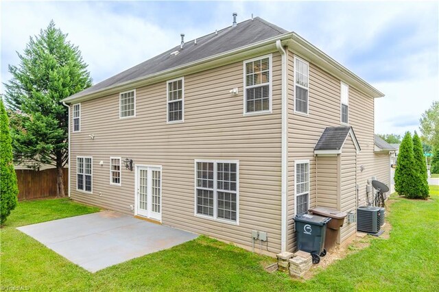 back of property with a yard and a patio