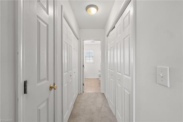 hallway with light colored carpet