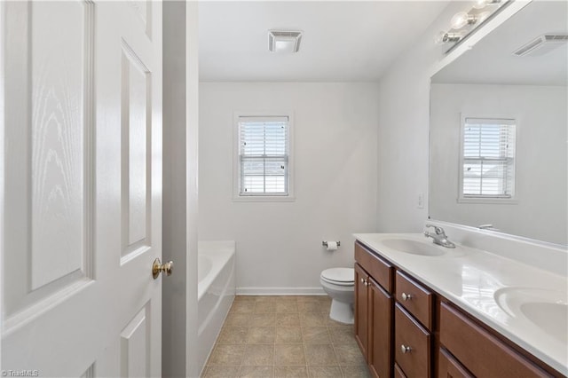 bathroom with a bathing tub, vanity, and toilet