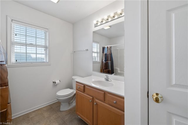 bathroom featuring vanity, toilet, and walk in shower