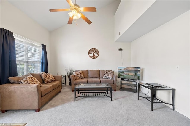 living room with light colored carpet, high vaulted ceiling, and ceiling fan