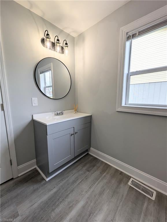 bathroom featuring a healthy amount of sunlight, visible vents, and baseboards