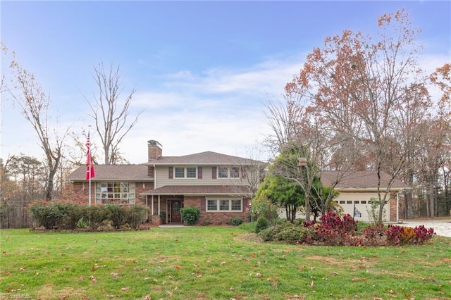 tri-level home featuring a front yard and a garage