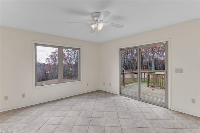 unfurnished room with ceiling fan and light tile patterned floors