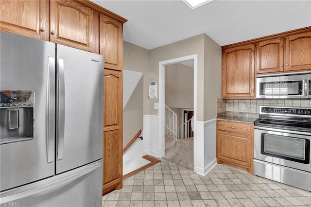 kitchen featuring appliances with stainless steel finishes and tasteful backsplash