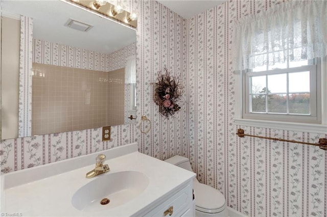 bathroom featuring vanity and toilet