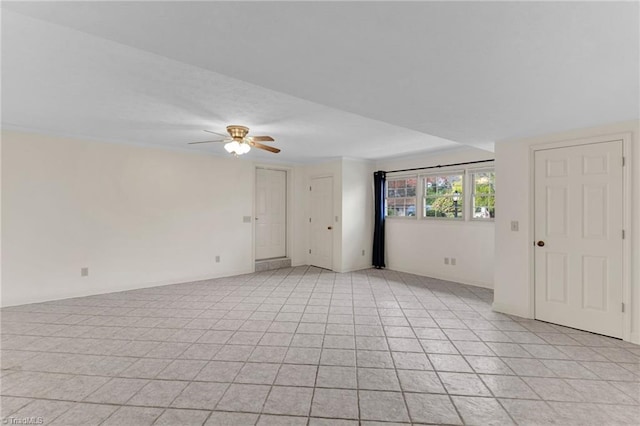 unfurnished room featuring ceiling fan and light tile patterned floors