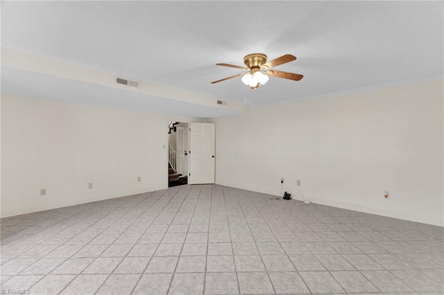 spare room featuring ceiling fan and ornamental molding