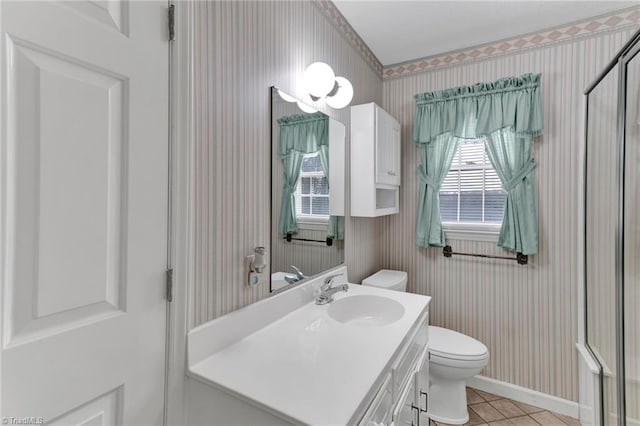 bathroom featuring tile patterned flooring, vanity, and toilet