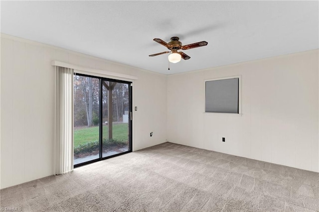 carpeted spare room with ceiling fan