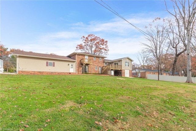 exterior space with a wooden deck and a front yard