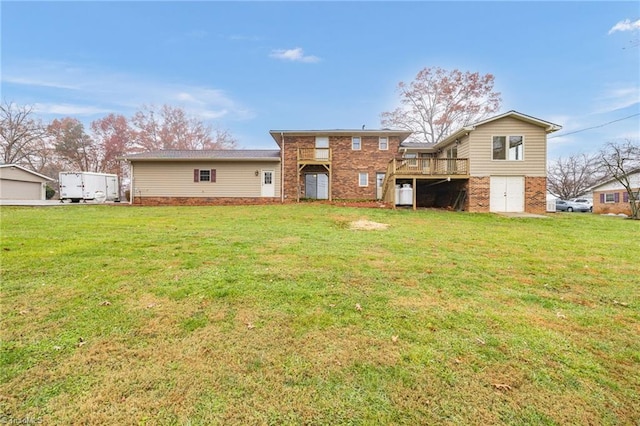 rear view of property with a yard and a deck