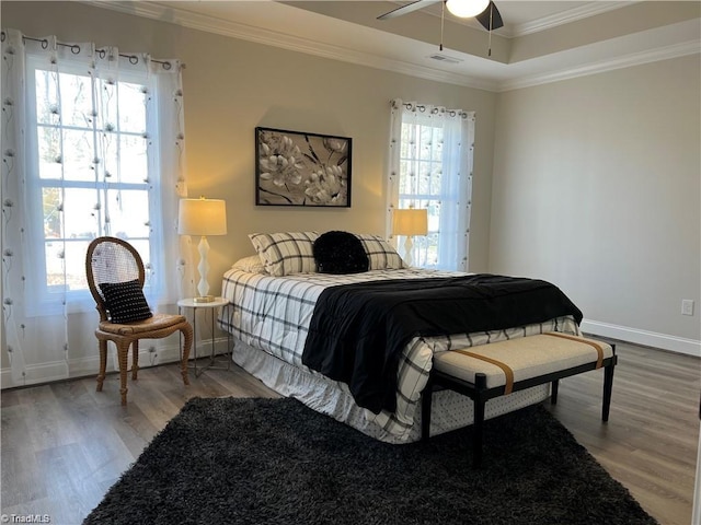 bedroom with hardwood / wood-style floors, ceiling fan, and ornamental molding