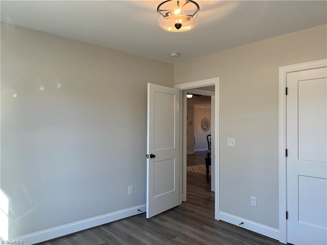 unfurnished bedroom with dark hardwood / wood-style floors