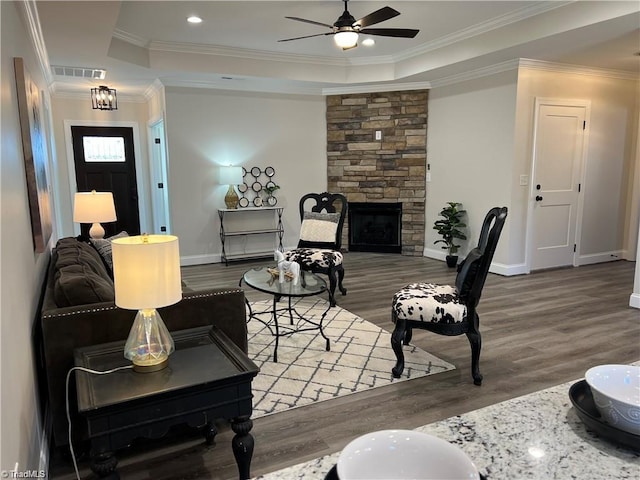 living room with ceiling fan, hardwood / wood-style flooring, and a fireplace