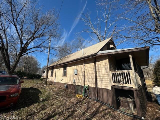 view of side of home featuring metal roof