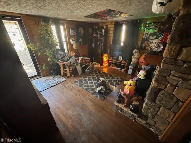 interior space featuring a textured ceiling and wood finished floors