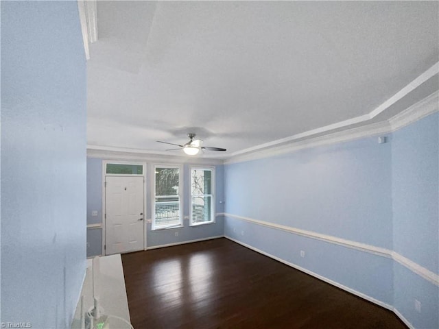 empty room featuring ceiling fan, crown molding, and dark hardwood / wood-style floors