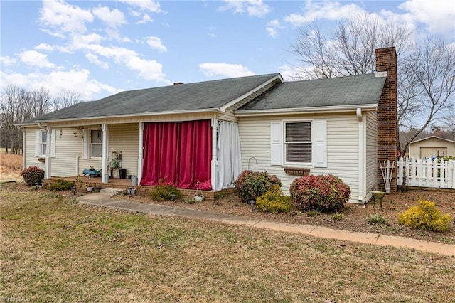 single story home with a porch, a chimney, and a front lawn