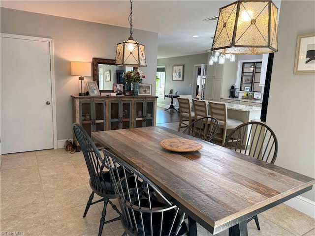 dining space with baseboards and visible vents