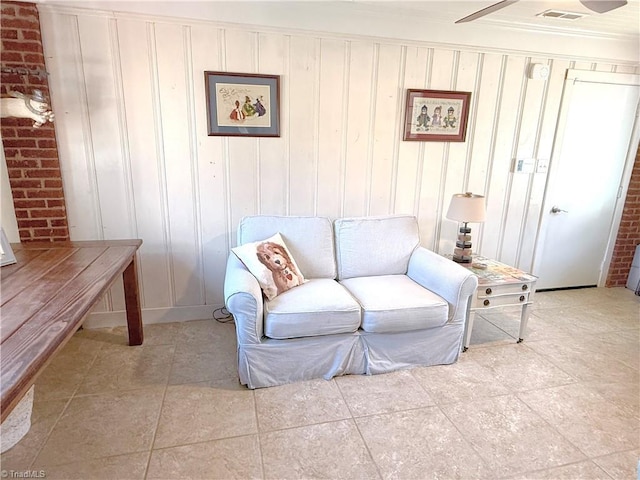 living room featuring visible vents, crown molding, and light tile patterned floors