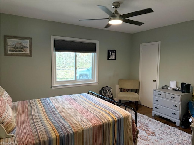 bedroom featuring dark wood-style flooring and ceiling fan