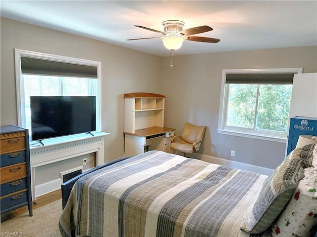 bedroom with a ceiling fan and baseboards