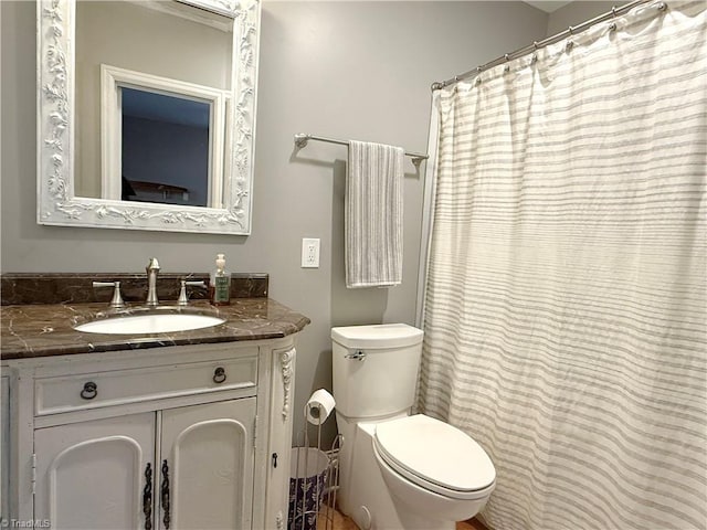 full bathroom featuring toilet and vanity