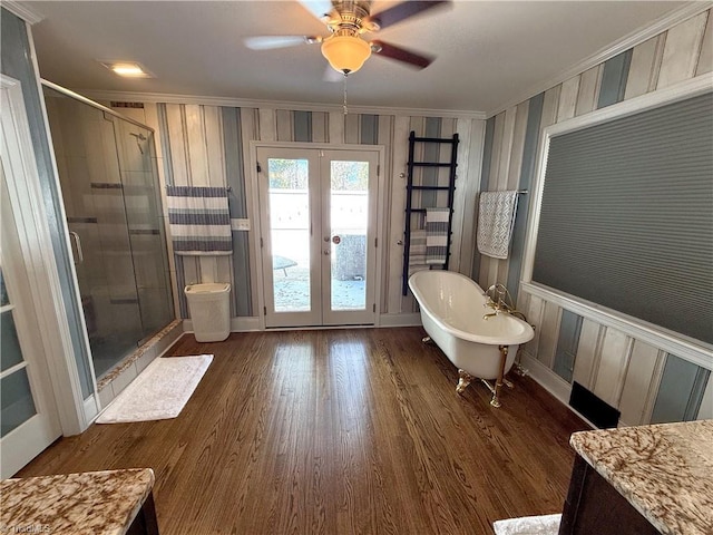 full bath featuring ornamental molding, french doors, a soaking tub, and a shower stall