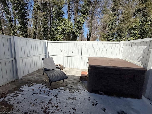 wooden deck with a fenced backyard