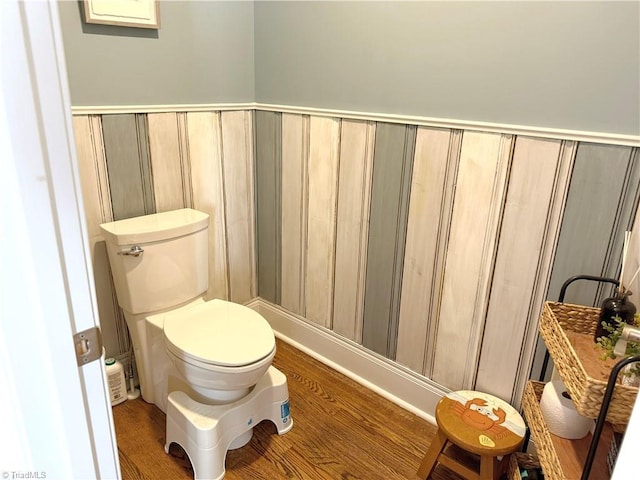 bathroom featuring wood finished floors and toilet