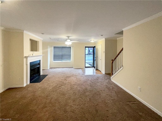 unfurnished living room featuring ornamental molding, light colored carpet, and ceiling fan