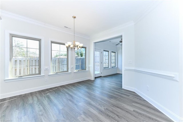 unfurnished dining area with ceiling fan with notable chandelier, dark hardwood / wood-style flooring, and crown molding