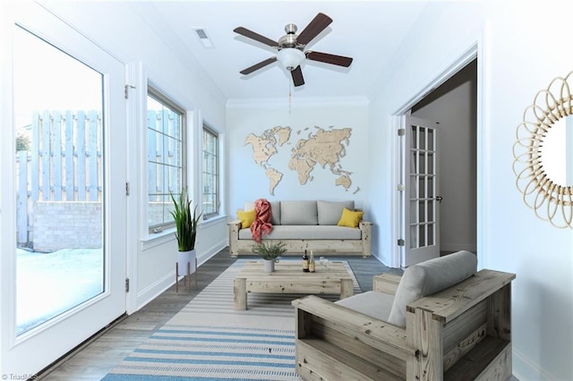 sunroom featuring ceiling fan and a wealth of natural light