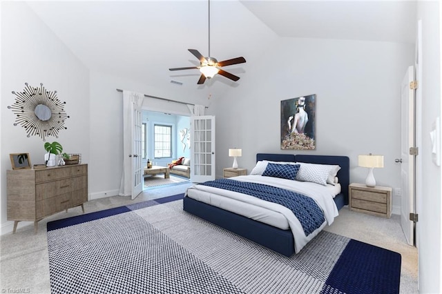 carpeted bedroom with ceiling fan, french doors, and lofted ceiling