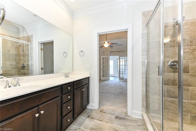 bathroom featuring a shower with door, vanity, ceiling fan, and ornamental molding