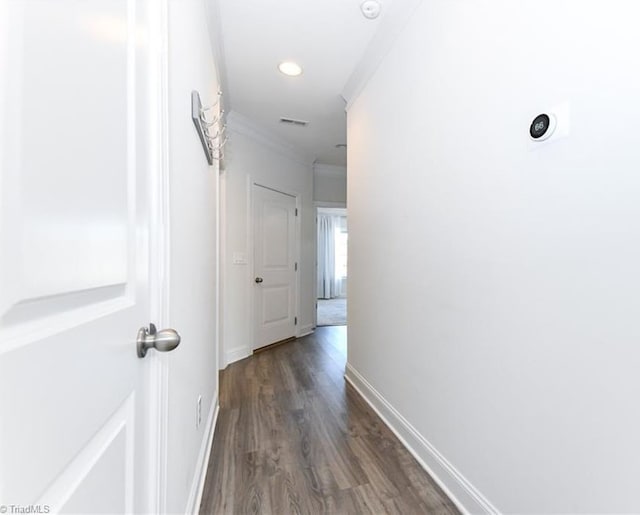 hallway with crown molding and dark wood-type flooring