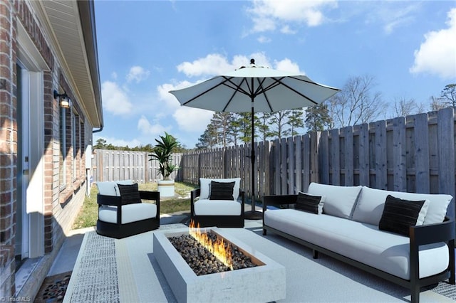 view of patio / terrace featuring an outdoor living space with a fire pit