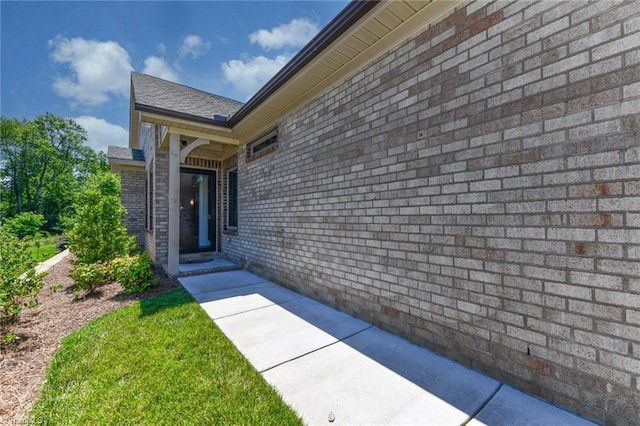 view of exterior entry with a patio area