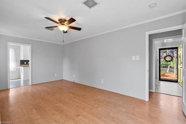 unfurnished living room featuring crown molding, a ceiling fan, and light wood-type flooring