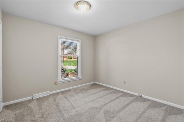 unfurnished room featuring visible vents, baseboards, and carpet flooring