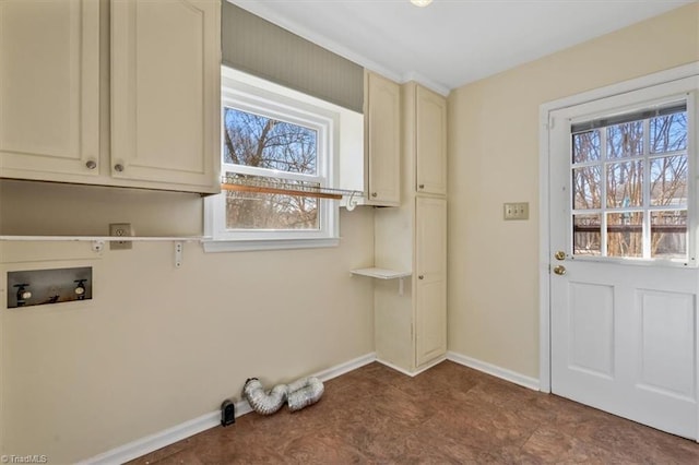 washroom with hookup for a washing machine, cabinet space, and baseboards