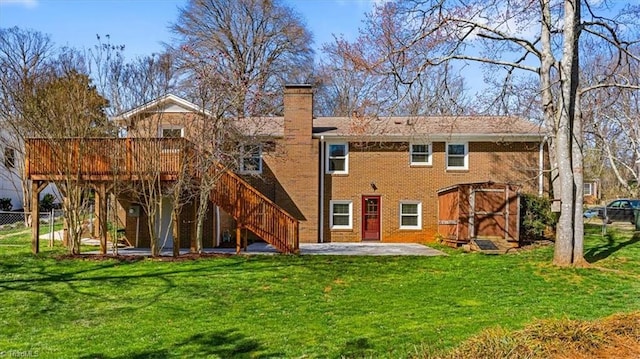 rear view of property featuring stairway, a yard, and fence