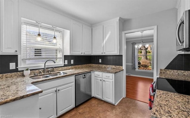 kitchen with a sink, decorative backsplash, appliances with stainless steel finishes, and white cabinets